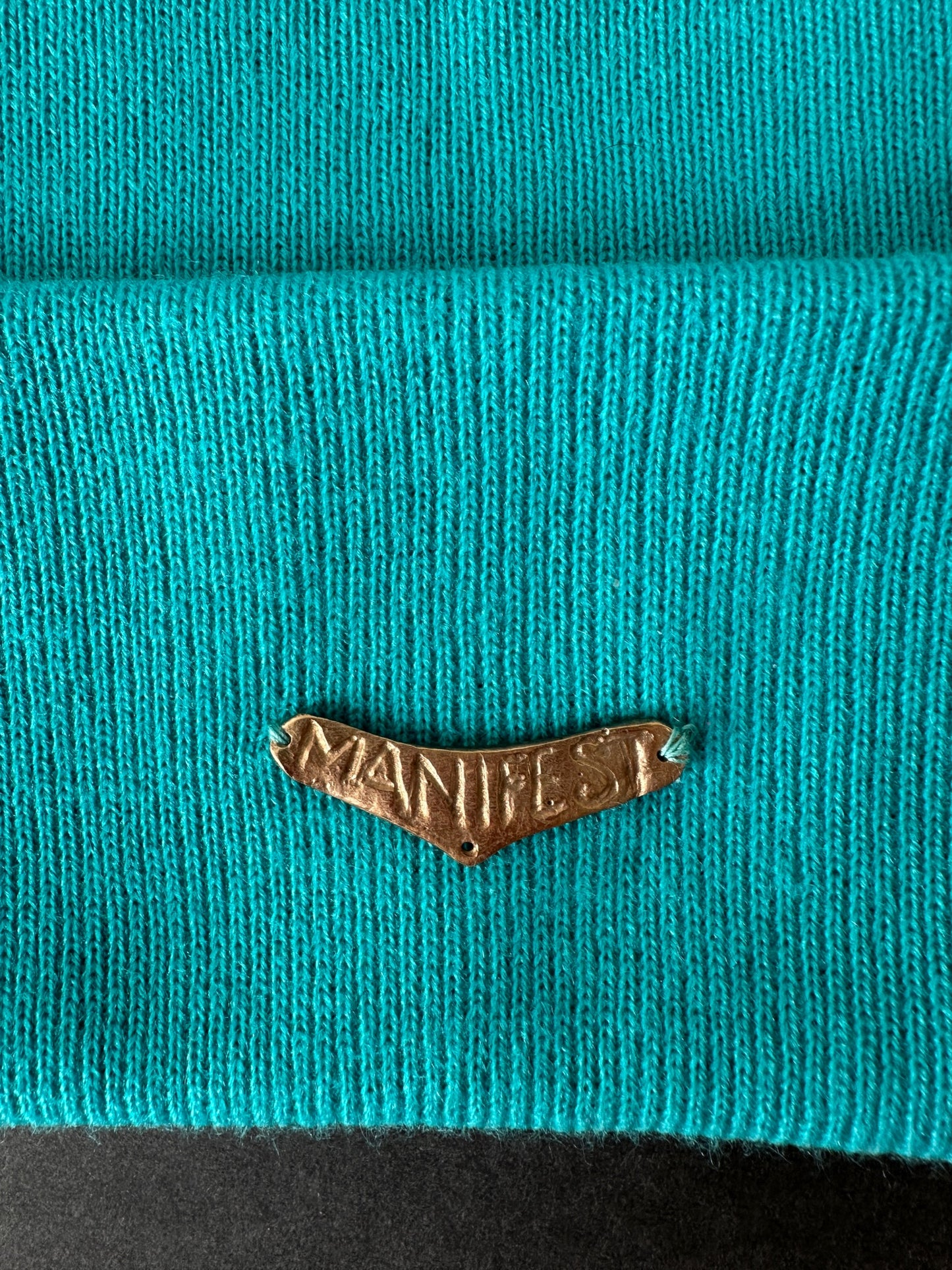 025. Bronze “MANIFEST” Beanie in turquoise