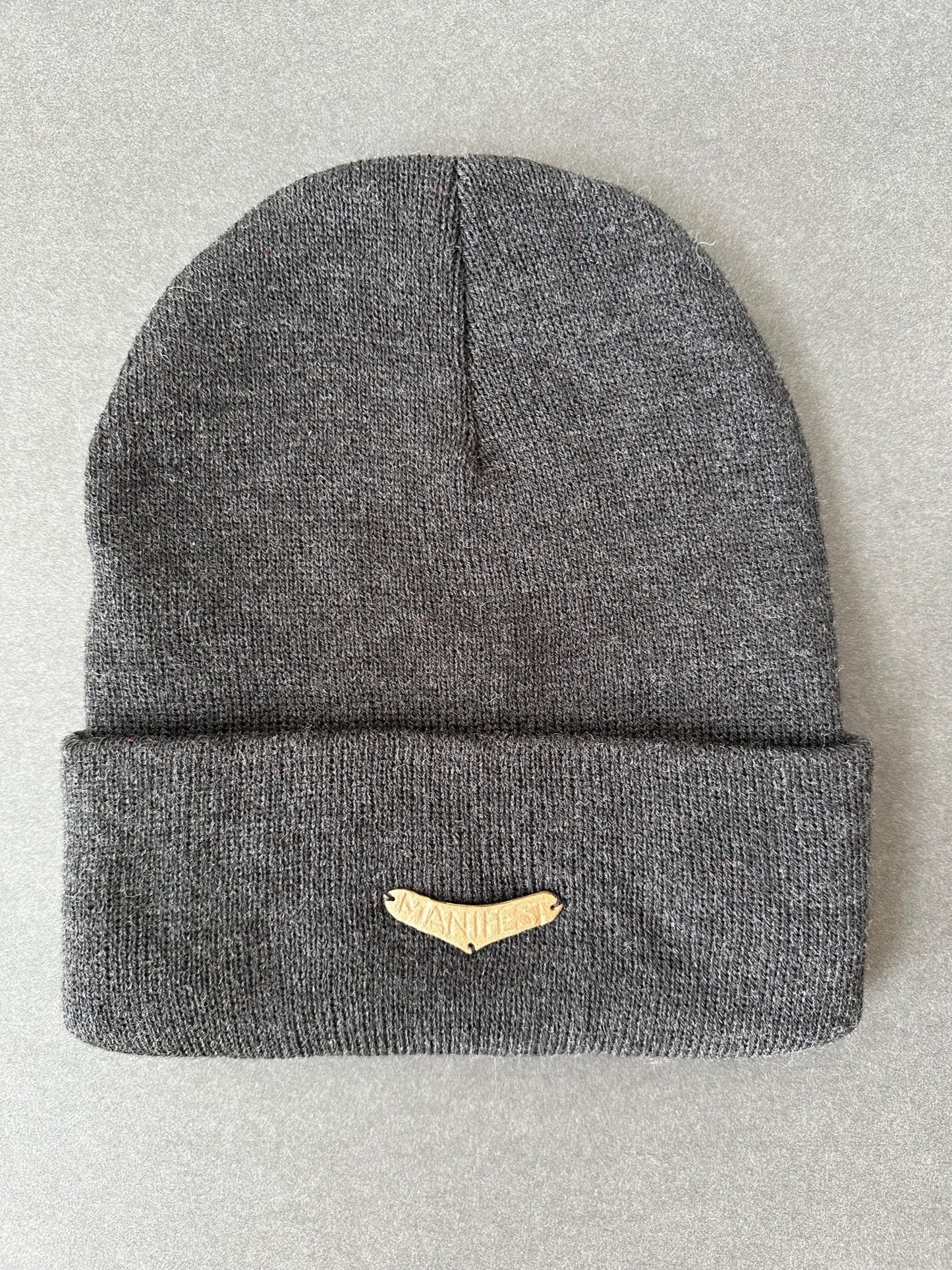 027. Bronze “MANIFEST” Beanie in charcoal gray